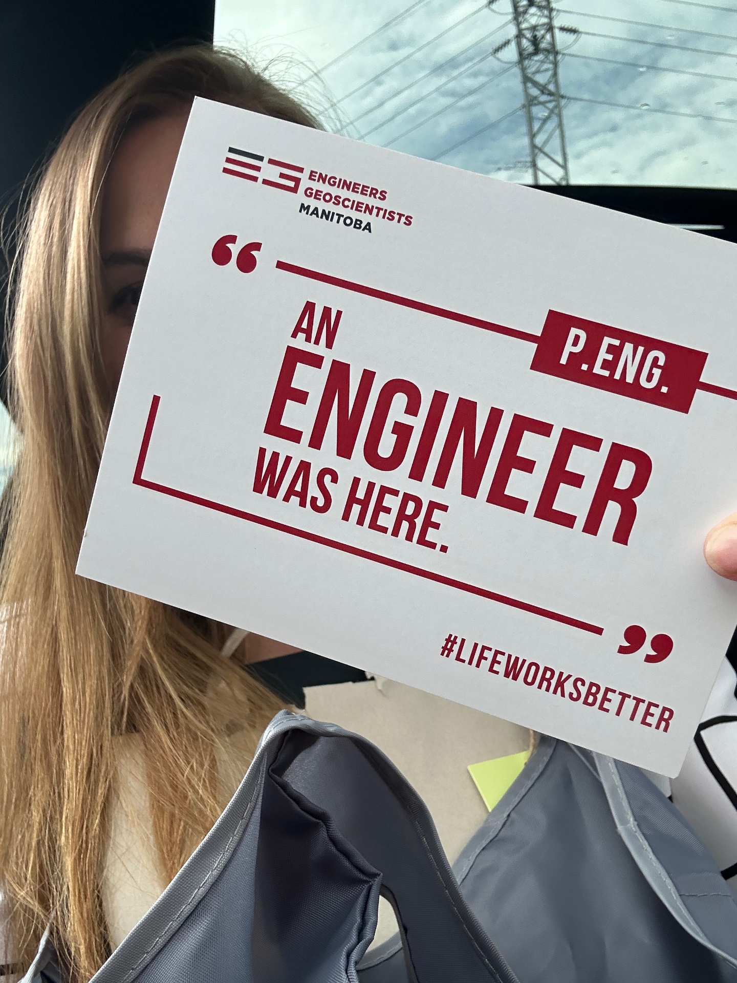 Trina Semenchuk holding an Engineers Geoscientists Manitoba sign that reads An Engineer Was Here